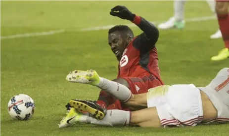  ?? CHRIS YOUNG/THE CANADIAN PRESS ?? Toronto FC forward Jozy Altidore, left, is brought down by Atlanta United midfielder Carlos Carmona during the first half at BMO Field on Saturday.