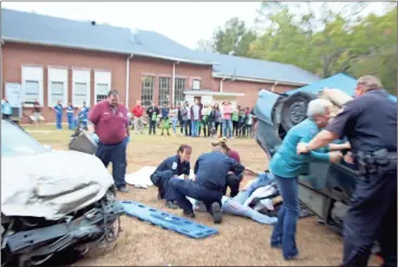  ??  ?? Emergency officials show off what it’s like to be at a wreck scene to Polk 9th graders.