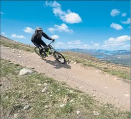  ??  ?? A mountain biker makes their way down the track at Nevis Range