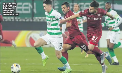  ??  ?? Chased down: Celtic’s Mikey Johnston attempts to evade the attention of Cluj