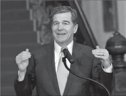  ?? The Associated Press ?? BILL SIGNING: North Carolina Gov. Roy Cooper holds a press conference Thursday at the Executive Mansion in Raleigh, N.C., to announce that he signed a HB142, a compromise replacemen­t bill for HB2, that the N.C. General Assembly passed earlier in the day.