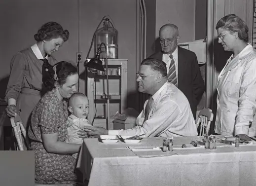  ?? ?? Kendrick, far right, watches a colleague inoculate a child against pertussis in 1942. Government officials had begun distributi­ng her team’s vaccine in 1940, drastic cally reducing d deaths.