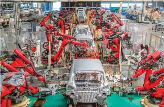  ?? ?? An automated production line runs in an intelligen­t factory workshop for new energy vehicles in Jinhua, East China’s Zhejiang Province, on April 1, 2024.