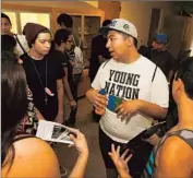  ?? Anne Cusack Los Angeles Times ?? FIFTH-YEAR STUDENT Nelson Guevara gives a tour to prospectiv­e Native American students.