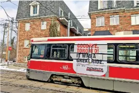  ??  ?? A streetcar travels a street in Toronto, Canada.