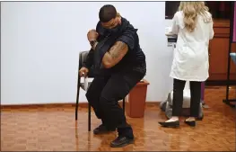  ?? JESSICA HILL — THE ASSOCIATED PRESS ?? Hartford Public Schools Safety Officer Victor Rodriguez flexes his arm muscle after receiving a Johnson & Johnson COVID-19vaccine at Hartford Hospital in Hartford, Conn., on Wednesday.