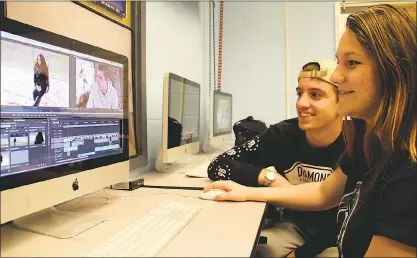  ?? SUBMITTED PHOTO ?? Career and Technology Education students Jesse Wade, left, and Shelby Burgess look over footage shot for “Soar to New Heights,” a short film they made for the 2016 film awards for the National Alternativ­e Education Associatio­n. Wade and Burgess, with...