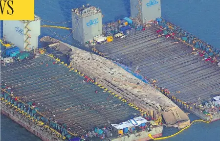  ?? AFP/GETTY IMAGES ?? The damaged Sewol ferry is shown between two barges after being raised during a salvage operation off the South Korean coast on Thursday. It’s been nearly three years since the Sewol went down with the loss of more than 300 lives, mostly students on a...