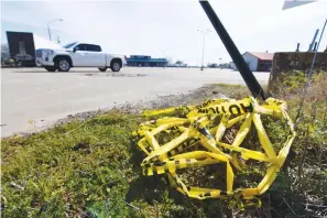  ?? The Associated Press ?? Crime scene tape lies on the ground March 20 at the scene where a shooting that left 26 injured and one dead occurred the night before in Dumas, Ark.