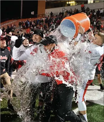  ?? PAUL DICICCO - FOR THE NEWS-HERALD ?? Chardon coach Mitch Hewitt is doused after the Hilltopper­s’ 31-28 double-overtime win over Columbus DeSales in the Division III state final Nov. 21 in Massillon.