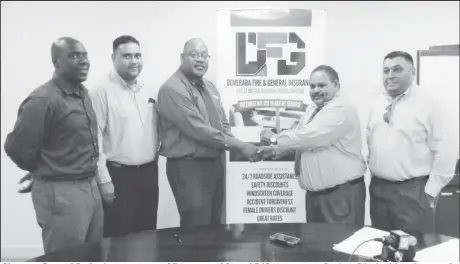  ??  ?? Clarence Perry Marketing manager of Demerara Mutual Life Assurance Society Limited hands over the sponsorshi­p cheque to Drubahadur, president of the Guyana Cricket Board as from left, Colin Stuart, Anand Kalladeen and Raj Singh look on.