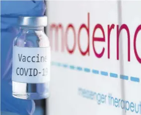  ??  ?? This file photo taken on November 18, 2020 shows a bottle reading “Vaccine Covid-19” next to the Moderna biotech company logo