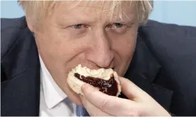  ?? Photograph: Dan Kitwood/AFP via Getty Images ?? ‘Like grainy VHS footage of a toddler eating a cracker for the first time.’ Boris Johnson eating a scone at Rodda’s creamery in Redruth, Cornwall, November 2019.