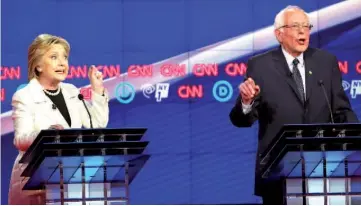  ??  ?? Clinton and Sanders (right) debate during the CNN Democratic Presidenti­al Primary Debate at the Duggal Greenhouse in the Brooklyn Navy Yard in New York City. — AFP photo