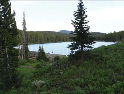  ?? RJ SANGOSTI — THE DENVER POST ?? A family takes an evening walk around Lake Irwin on June 25, 2020, outside of Crested Butte, Colorado.