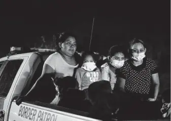  ?? Gregory Bull / Associated Press file photo ?? Migrants from Honduras turn themselves in at the border in May 2021 in La Joya. The CDC’s order under Title 42 allows the immediate expulsion of certain migrants in the interest of public health.