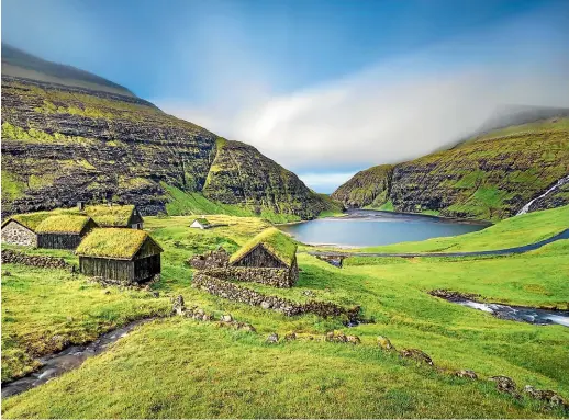  ??  ?? It can be a little hard to spot the village of Saksun on the island of Streymoy in the Faroe Islands.