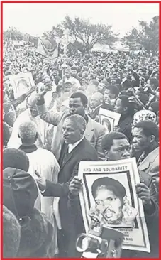  ??  ?? ANGER ERUPTS: People protesting Steve Biko 's arrest, holding up placards showing Biko in handcuffs