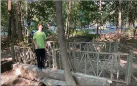  ?? PHOTO COURTESY OF MARI PALIGA ?? RIGHT: Walter Paliga stands on his improved Eagle Scout project at Drayton Plains Nature Center in Waterford Twp.