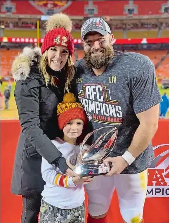  ?? PHOTO COURTESY OF ARREMONY FAMILY ?? Anthony, Jessica and 5-year-old Rex Sherman pose with the AFC Championsh­ip trophy after the Kansas City Chiefs defeated the Tennessee Titans 35-24 on Jan. 19 at Arrowhead Stadium. Anthony and Jessica, the former Jessica Arremony of Griswold, met as student-athletes at UConn and will continue their journey today in Miami when Sherman and the Chiefs face the San Francisco 49ers in Super Bowl 54.