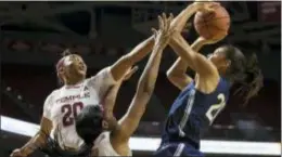  ?? CHRIS SZAGOLA — THE ASSOCIATED PRESS ?? Connecticu­t’s Olivia Nelson-Ododa, right, shoots with Temple’s Alexa Williamson, left, reaching for the block. Shantay Taylor, center, fouled Nelson-Ododa on the play.