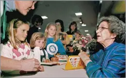  ?? Vern Fisher Associated Press ?? AN INSPIRATIO­N TO GENERATION­S Beverly Cleary signs books at the 1998 Monterey Bay Book Festival. Her Oregon upbringing inspired enduring characters such as Ramona Quimby.