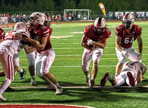  ?? Michael M. Santiago/Post-Gazette ?? Ryan Magiske, running back for Peters Township, center, finds a big hole and scores a short touchdown against North Hills Friday night at Peters Township High School.