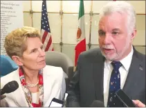  ?? Canadian Press photo ?? Premier Kathleen Wynne and Premier Philippe Couillard speak to reporters after an event at the Washington internatio­nal trade associatio­n in Washington, D.C., Friday.