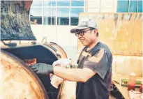  ?? Photos by Eric Wolfinger ?? S.F. native Marvin Lau, above, of Native Sons BBQ, works the smoker at a pop-up in S.F. Top: His stellar brisket.