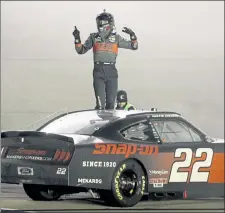  ?? AP ?? Austin Cindric celebrates after winning a NASCAR Xfinity Series auto race Friday in Sparta, Ky.