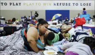  ?? DAVID GOLDMAN — AP FILE PHOTO ?? Annette Davis kisses her son Darius, 3, while staying at a shelter in Miami after evacuating from their home in Florida City, Fla., ahead of Hurricane Irma.