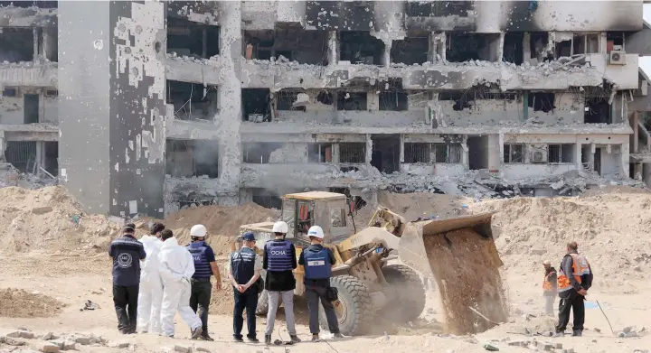  ?? — AFP ?? A United Nations team visits Gaza as Palestinia­n civil defence recover human remains from the grounds of Al Shifa hospital.