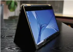  ??  ?? The HP Spectre x360 15 (2019) flips backward into tent mode. Toting around as a tablet, though, isn’t worth the effort. Note the large bezels, top and bottom.