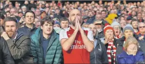  ?? GETTY IMAGES ?? A tense Arsenal supporter during a match against Tottenham Hotspur.