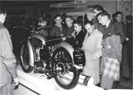  ??  ?? The Brylcreem boys! Note the hair styles as admirers cast their eyes over the delightful 200cc Triumph Tiger Cub – but with the hire-purchase restrictio­ns of the time, where would the £106 come from?