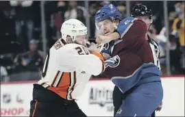  ?? David Zalubowski Associated Press ?? AVALANCHE DEFENSEMAN Kurtis MacDermid, a former King, throws a punch at Ducks left wing Nicolas Deslaurier­s during the first period Wednesday.