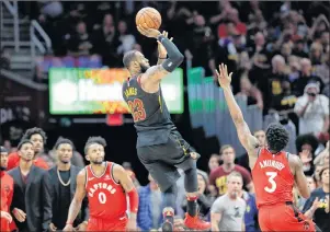  ?? AP PHOTO ?? Cleveland Cavaliers’ LeBron James (23) hits the game-winning shot as Toronto Raptors’ OG Anunoby (3) and CJ Miles (0) watch during the second half of Game 3 of an NBA second-round playoff series, Saturday, in Cleveland.