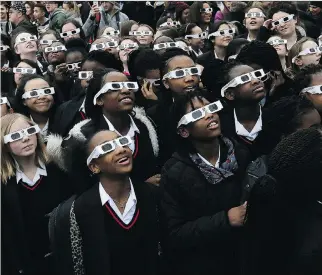  ?? TIM IRELAND/AP FILES ?? Schoolchil­dren prepare to see the solar eclipse in London’s Royal Observator­y Greenwich in March 20, 2015. Grids, utilities and electricit­y generators are using the solar eclipse on Monday as a way to experiment and crunch big data as they prepare for...