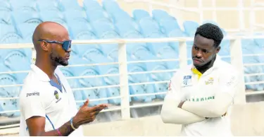  ?? PHOTO BY LENNOX ALDRED ?? West Indies and Barbados Pride captain Kraigg Brathwaite (left) has a chat with Jamaica Scorpions batsman Kirk McKenzie following their West Indies Championsh­ip match at Sabina Park last Saturday.