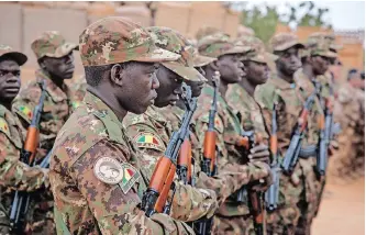  ?? | AFP ?? MALIAN soldiers during a handover ceremony of the Barkhane military base from the French to the Malian army in Timbuktu last month. France’s lacklustre eight-year military presence in Mali and in the Sahel has spurred Mali’s leaders to turn to Russia for solutions to the country’s security problems, say the writers.