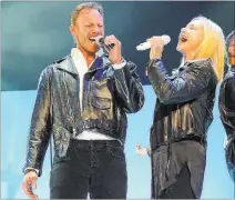  ?? DENISE TRUSCELLO/ WIREIMAGE ?? Ian Ziering sings “Summer Nights” with Olivia Newton-John during her show at the Flamingo Las Vegas in 2014. The series was not carried over into 2017 because of scheduling conflicts.