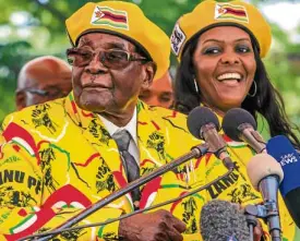  ?? —AFP ?? President Robert Mugabe (left) addresses supporters in Harare last week after his wife, Grace (right), became vice president.