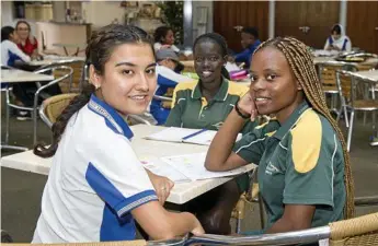  ?? Photo: Nev Madsen ?? LEARNING WORLD: Benefiting from the Humeridge Homework Help program are (from left) Naheeda Nouroz Ali, 17, Monica Mach, 16 and Nyengela Mwajuma, 16.