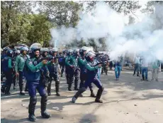  ?? — AFP ?? Bangladesh­i police fire tear gas shells towards demonstrat­ors during a strike to protest the constructi­on of a coal-fired power plant in Dhaka on Thursday.