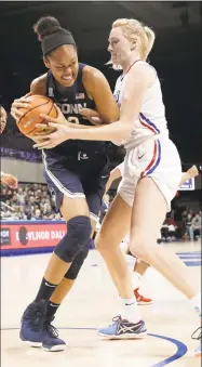  ?? Tony Gutierrez / Associated Press ?? UConn’s Azurá Stevens, left, and SMU’s Stephanie Collins compete for a rebound during Saturday’s game in Dallas.