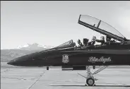  ?? Jenny Sparks / Loveland Reporter-herald ?? U.S. Navy Lt. Julius Bratton, left, and Lt. Katlin Forster with the Blue Angels take off some flight gear after landing Tuesday at the Northern Colorado Regional Airport in Loveland.