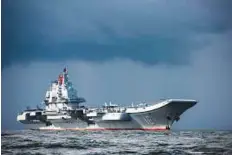  ?? AFP ?? China’s sole aircraft carrier, the Liaoning, arriving in Hong Kong waters.The aircraft carrier passed through the Taiwan Strait yesterday, the island’s defence ministry said.