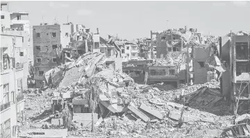  ??  ?? A general view shows debris near the central hospital of Raqa, which is one of the IS group’s last positions on the frontline. — AFP photo