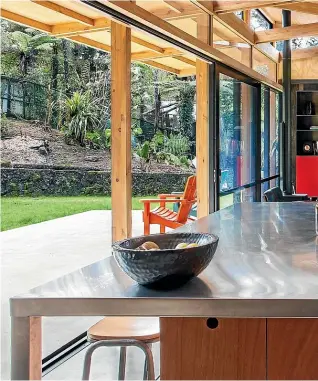  ?? DAVID STRAIGHT ?? The ceiling-hung wooden benchtop at Gittos House by Spacecraft Architects uses macrocarpa sourced from a felled windbreak.