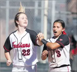  ?? Katharine Lotze/The Signal ?? Hart’s Morgan Jones (22) and Brooke Marquez (3) skip and sing as they celebrate their 7-0 win over Paraclete in a CIF-Southern Section playoff softball game at Hart on Tuesday.